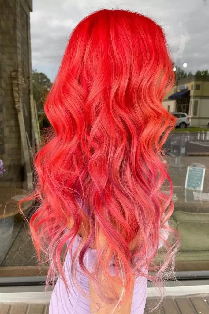 Coral hair color fading into lighter tips