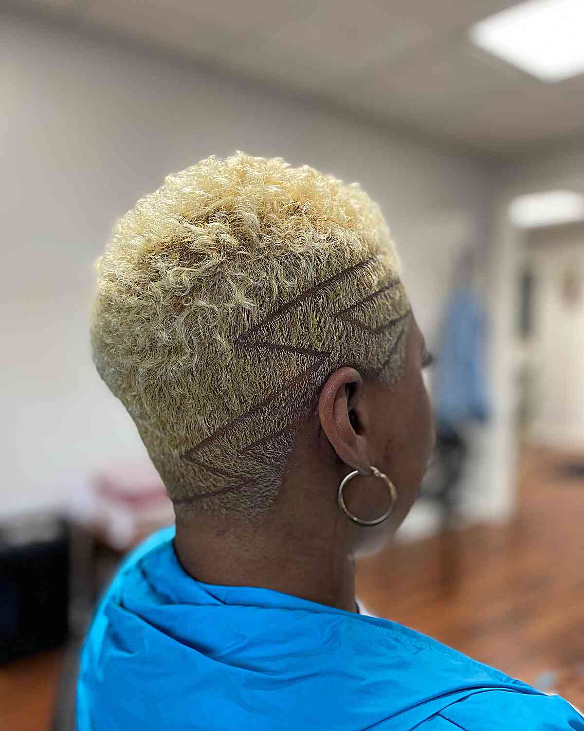 Vibrant blonde curly hair with a surgical line