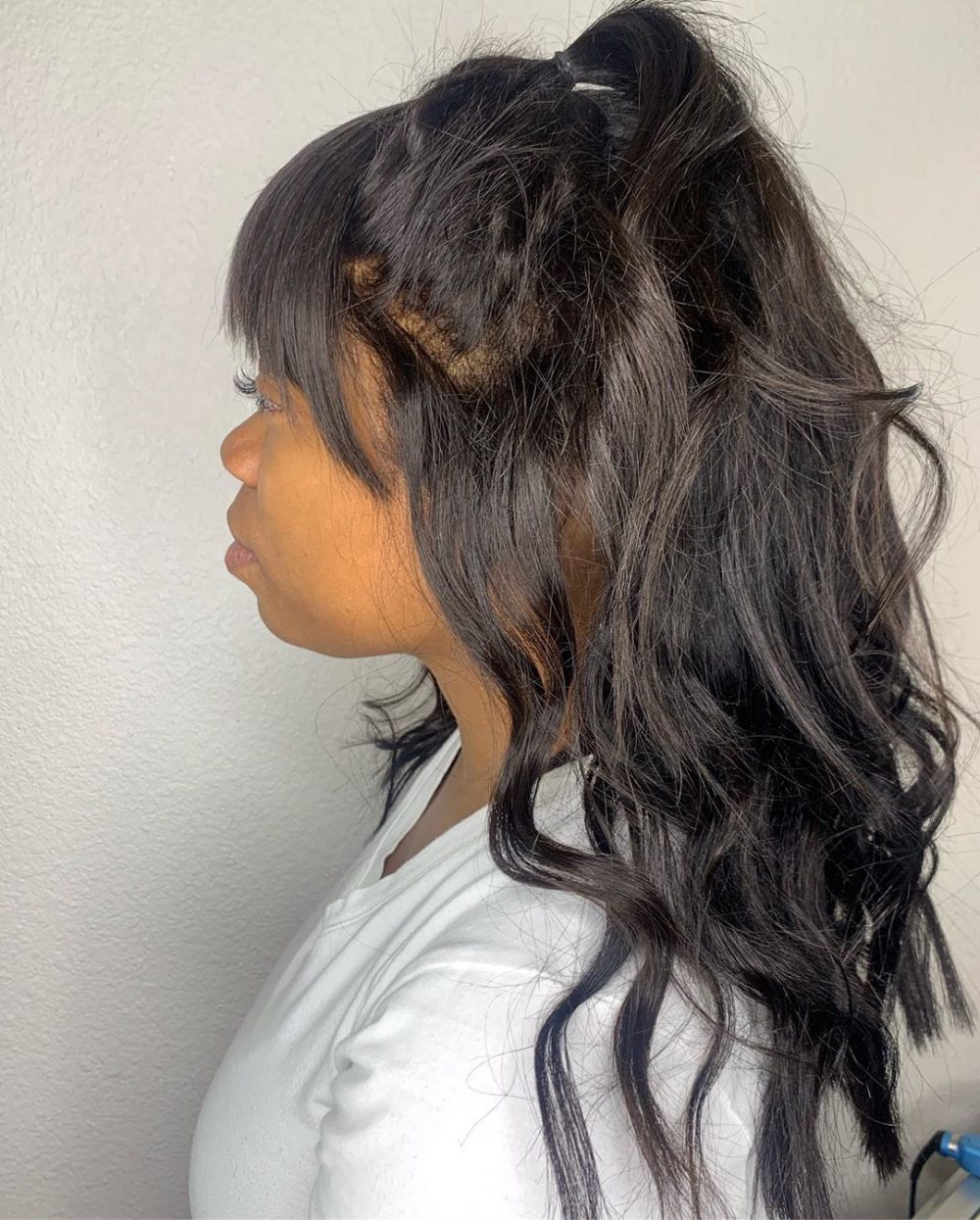 Sew-in hairstyle featuring bangs