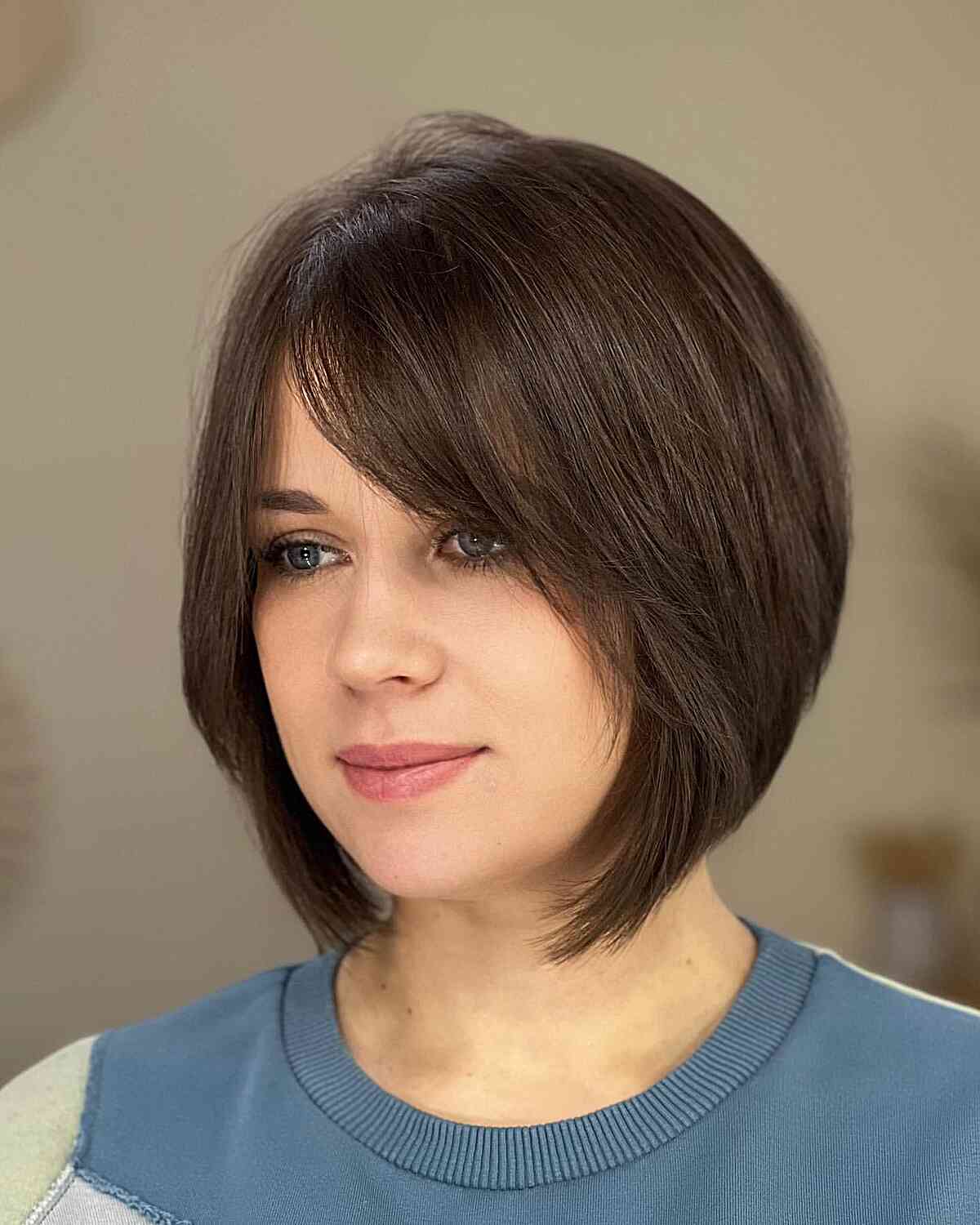 Soft graduated bob with bangs parted to the side