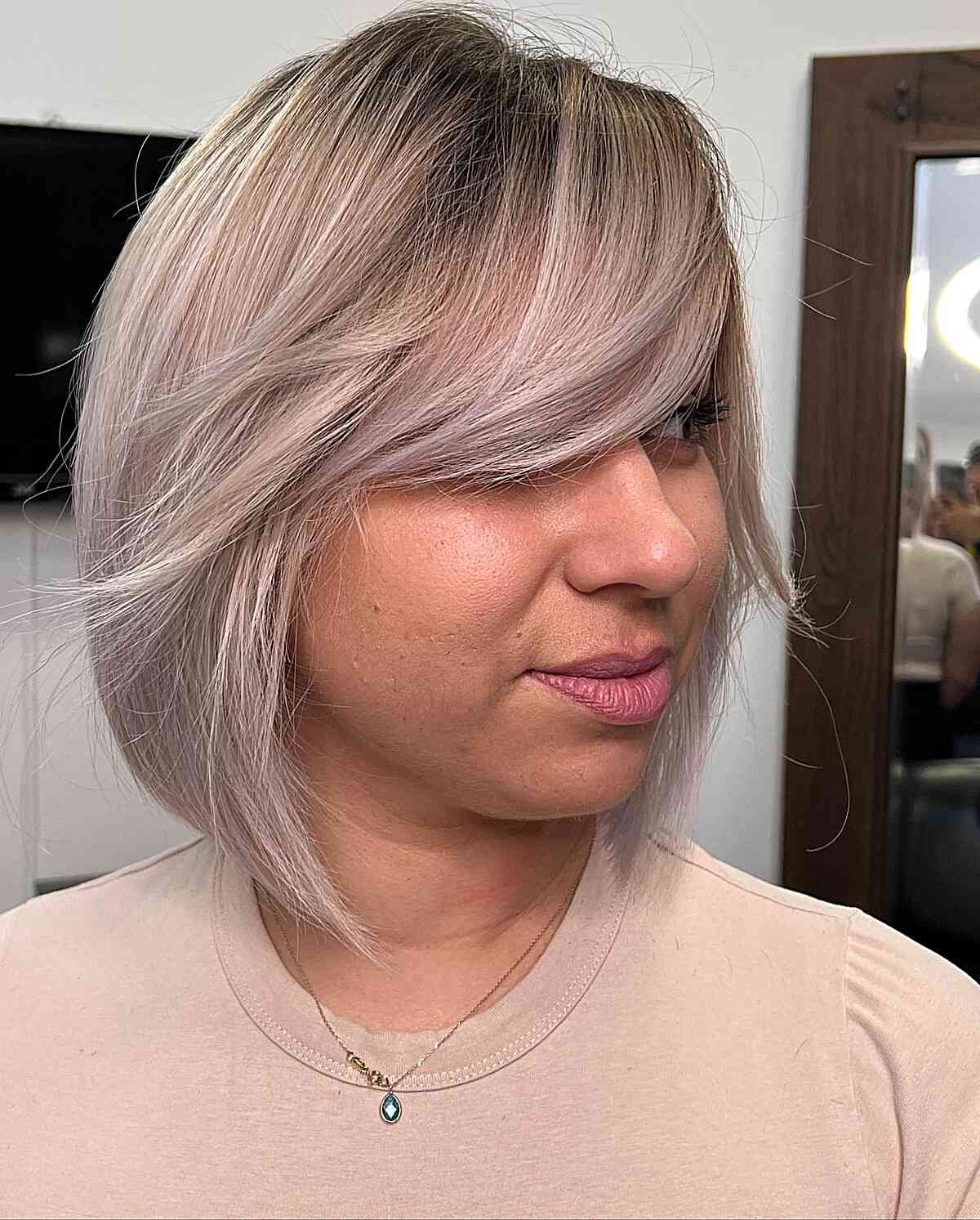 Lob with sweeping bangs in a silver blonde shade