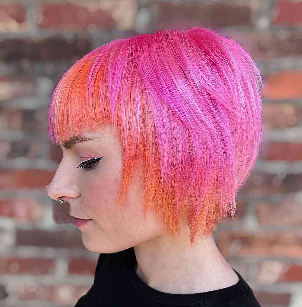 A choppy bob with neon tones and straight-cut bangs