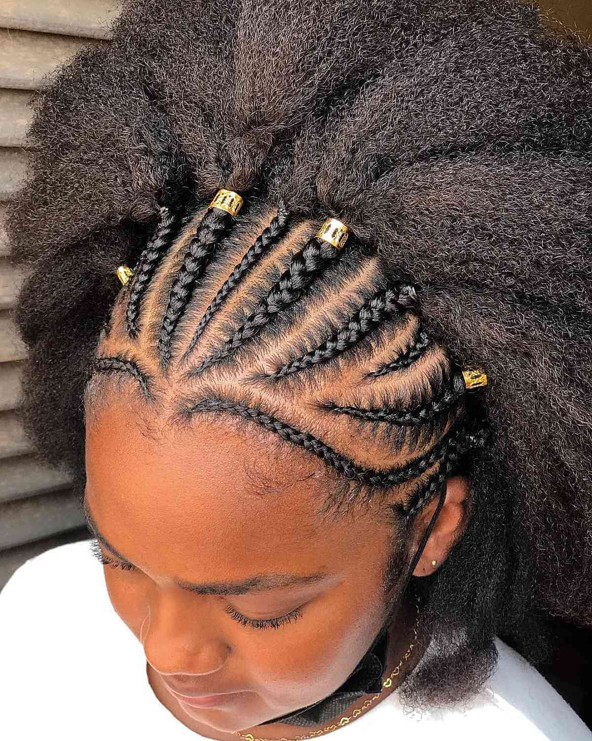 Ghana Braids Adorned with Beads and an Afro Texture