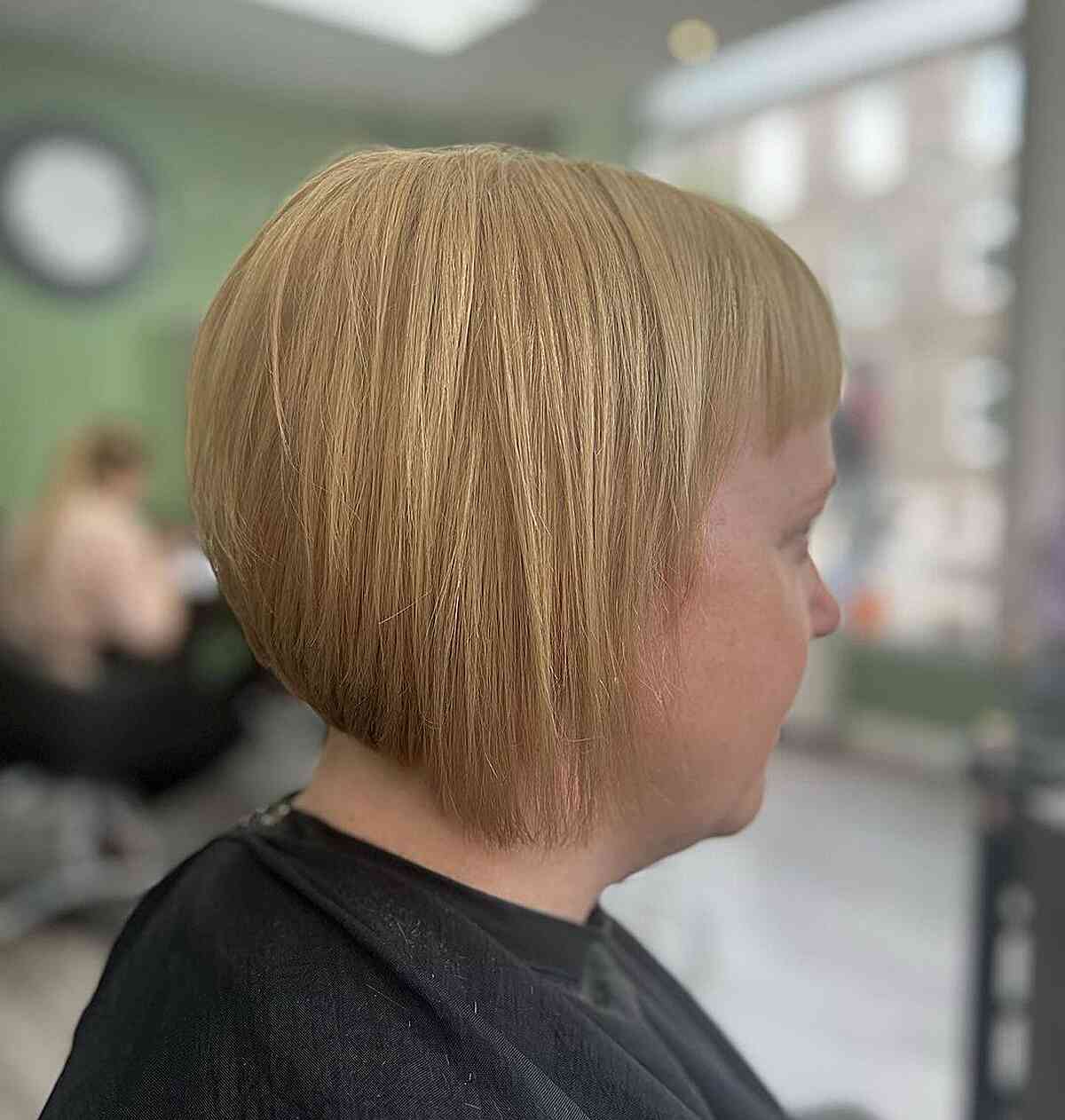 Short hair in a strawberry blonde shade with small bangs