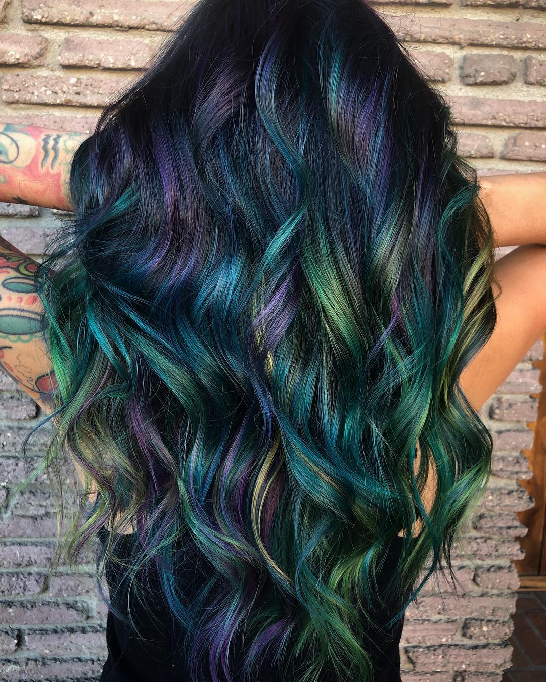 A balayage hair color blending shades of purple and green