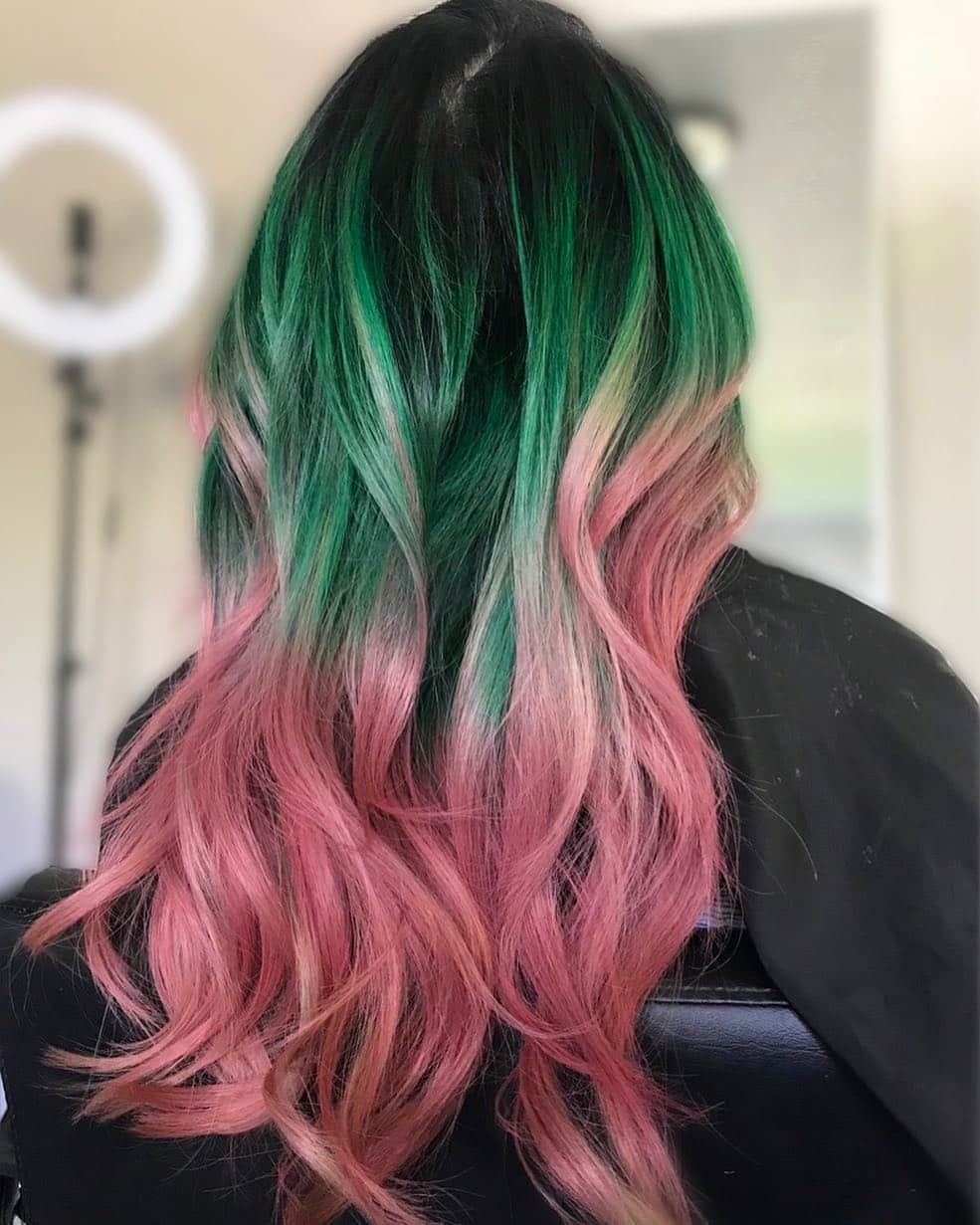 Hair color with a balayage technique blending shades of pink and green