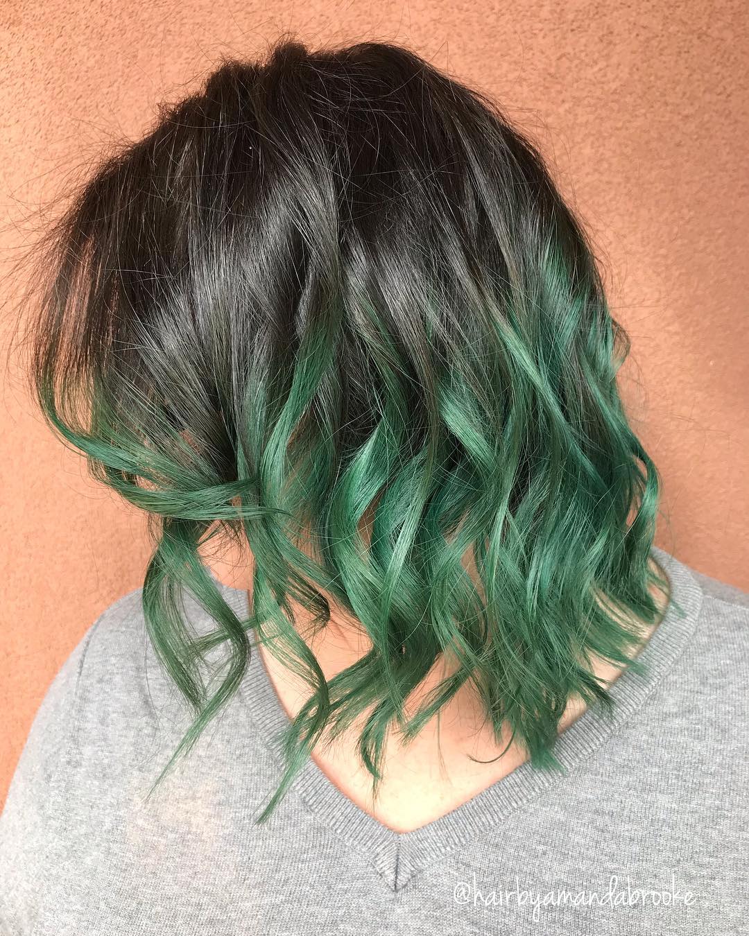 Hair transitioning in an ombre style from black to green