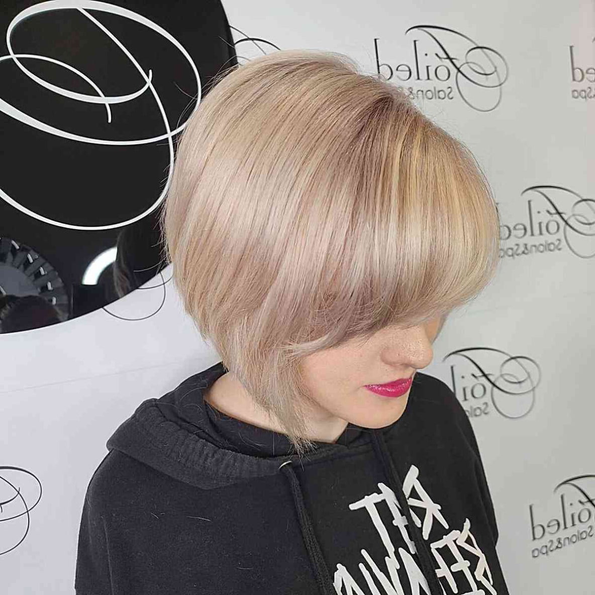 Layered bob with fringe in a sandy blonde hue