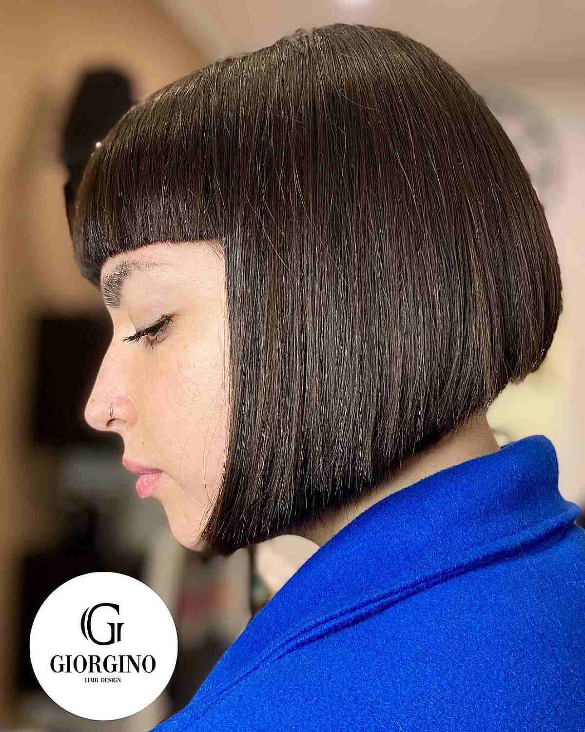 An inverted bob hairstyle with bold, full bangs