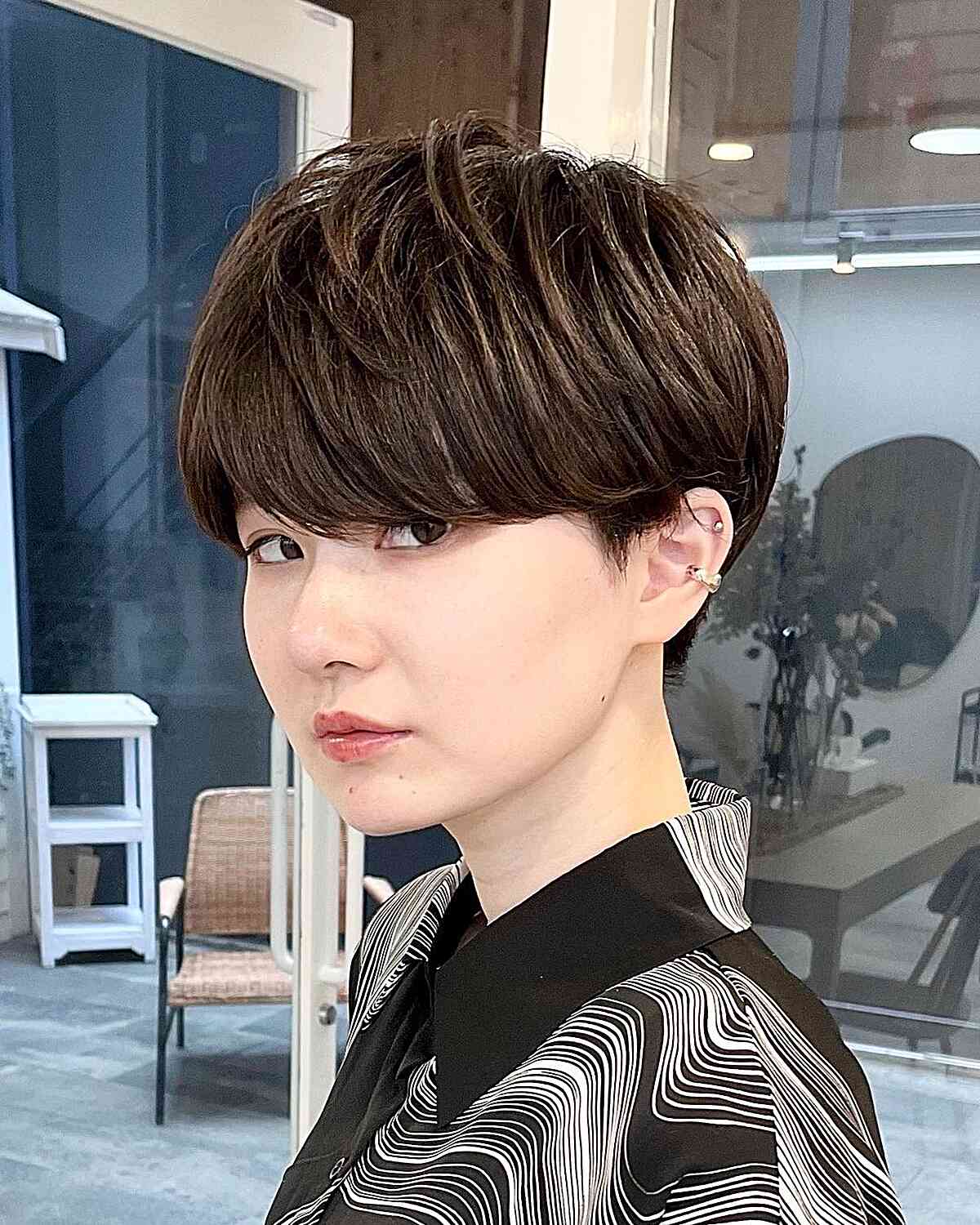 Gender-Neutral Short Haircut with Bangs and Layered Crown
