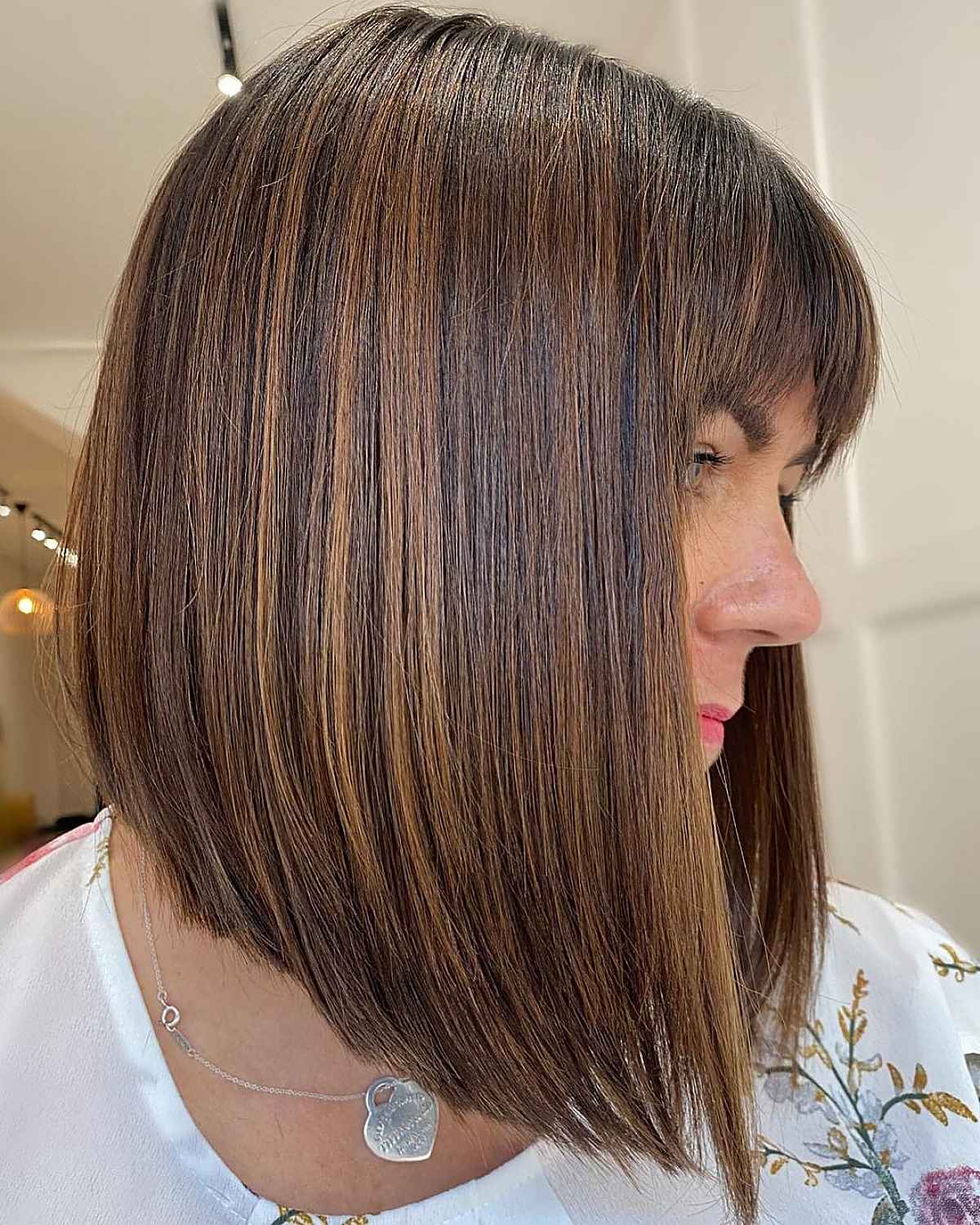 Trendsetting Brunette A-Line Lob Cut With Arched Bangs For A Chic, Balanced Look