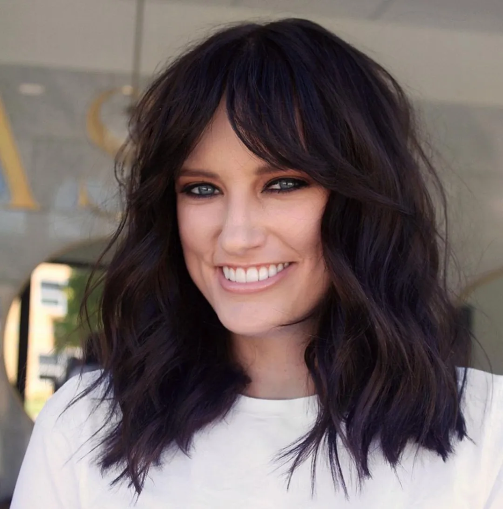 Charming Wavy Hairdo with Thick Bangs