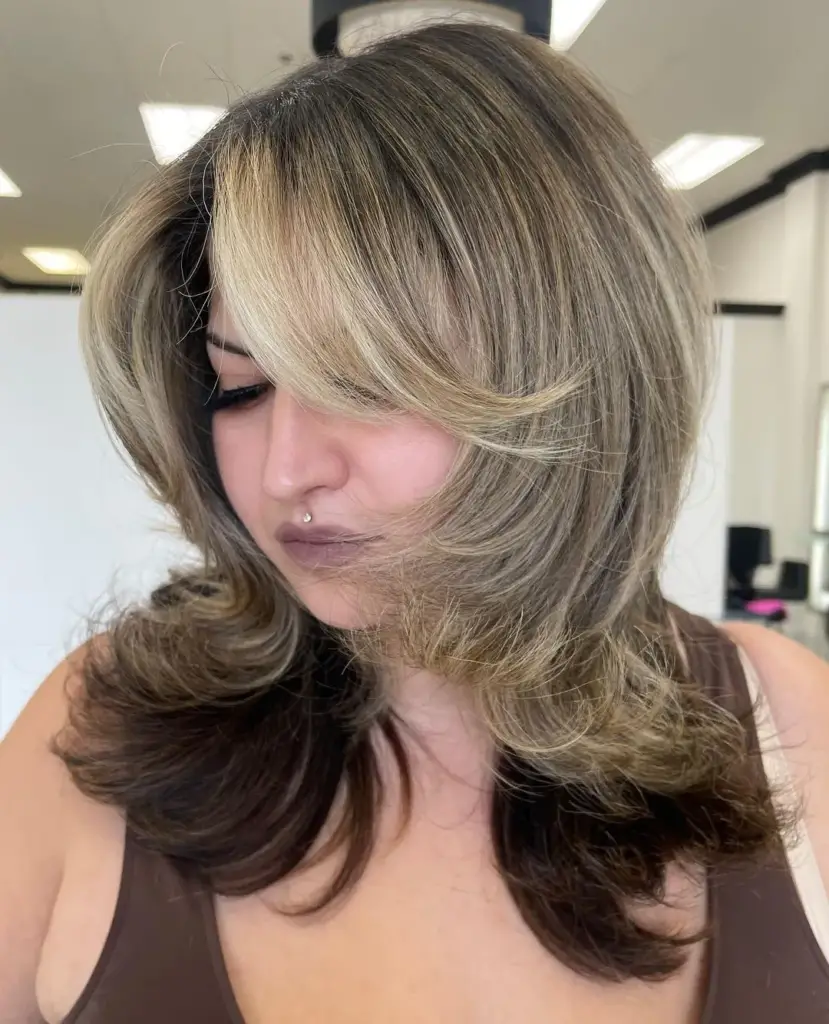 Layered Haircut with Flipped Ends and Curtain Bangs