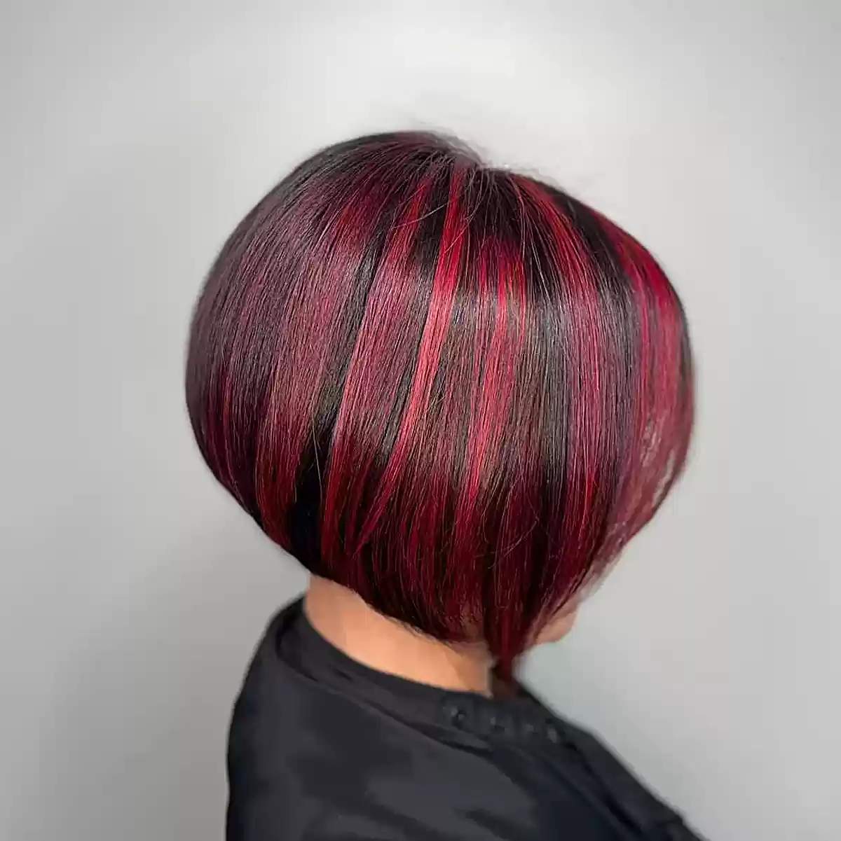Layered Stacked Inverted Bob Featuring Vibrant Red Highlights