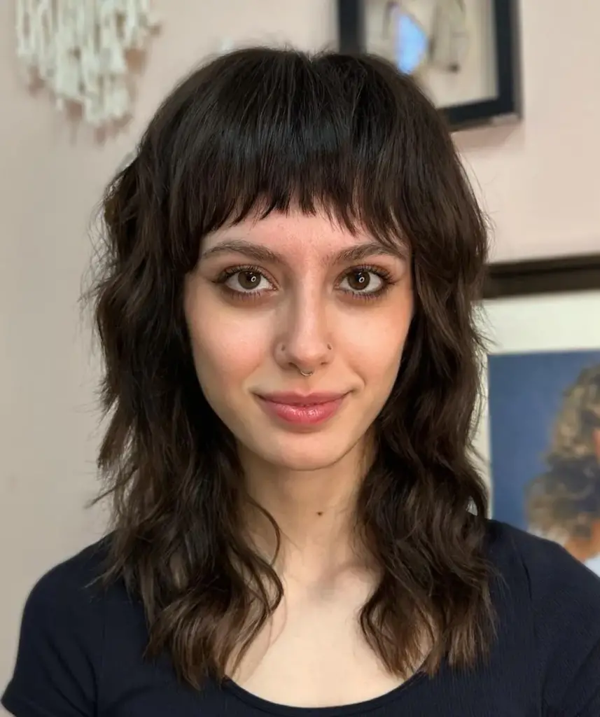 Layered Wavy Hairstyle with Curved Bangs