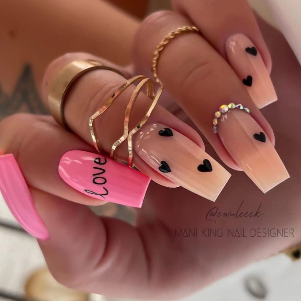 Refined Pink and Nude Heart Manicure with Sleek Black Accents for Valentine's Day Elegance